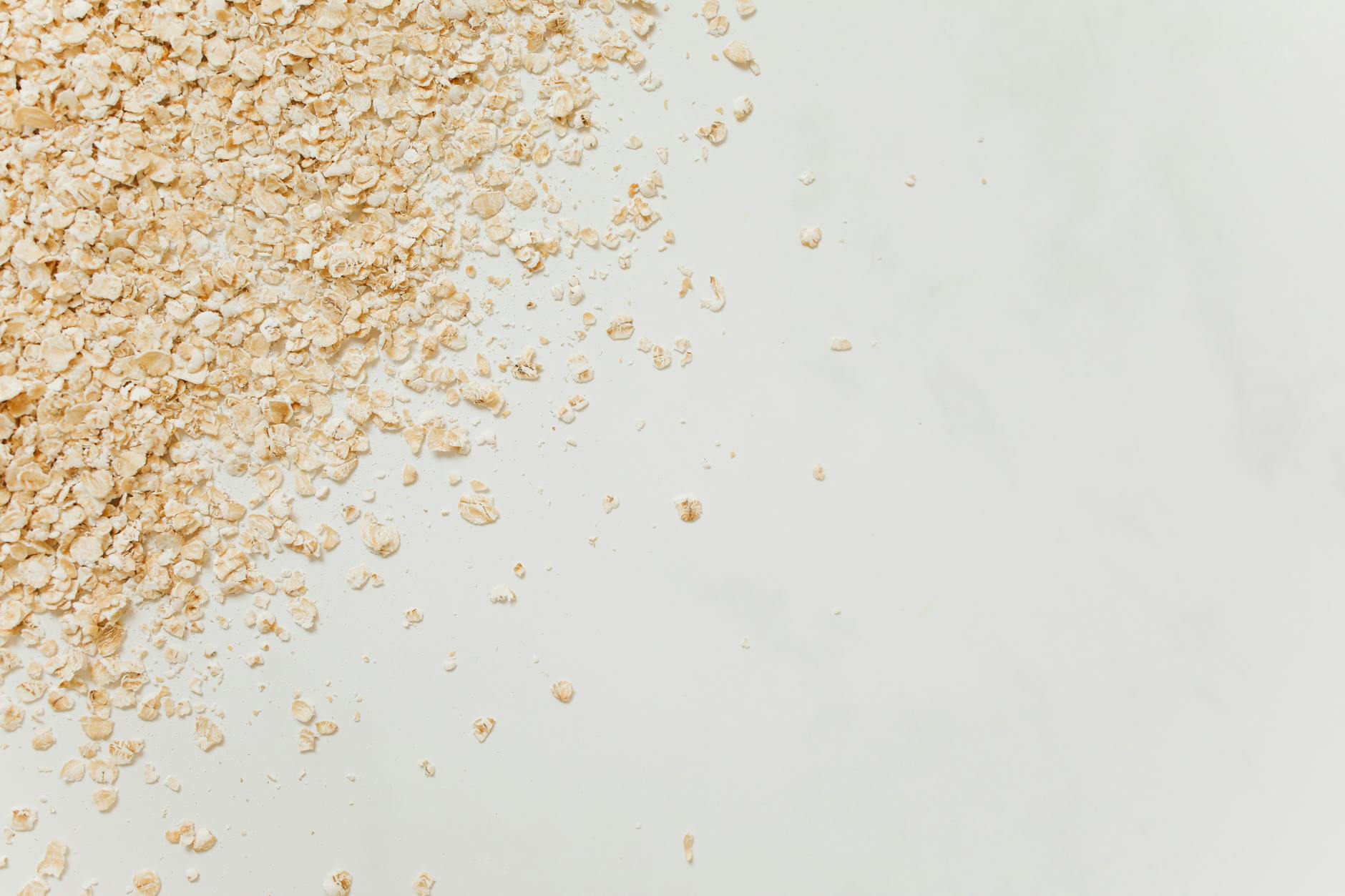 A bowl of oats with grains on a kitchen surface