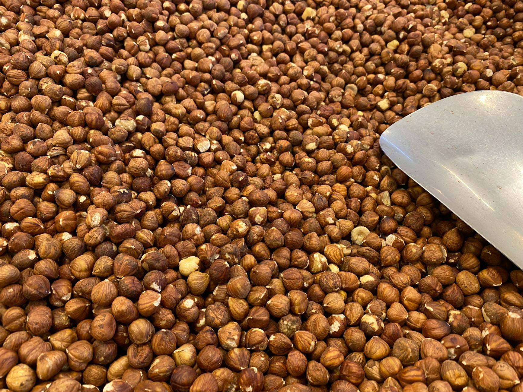 Pine nuts and hazelnuts in a wooden bowl - top manganese-rich foods